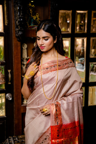Swarnachuri in beige and red with a grand palla